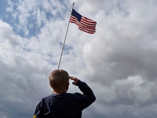 Little Boy saluting the American Flag
